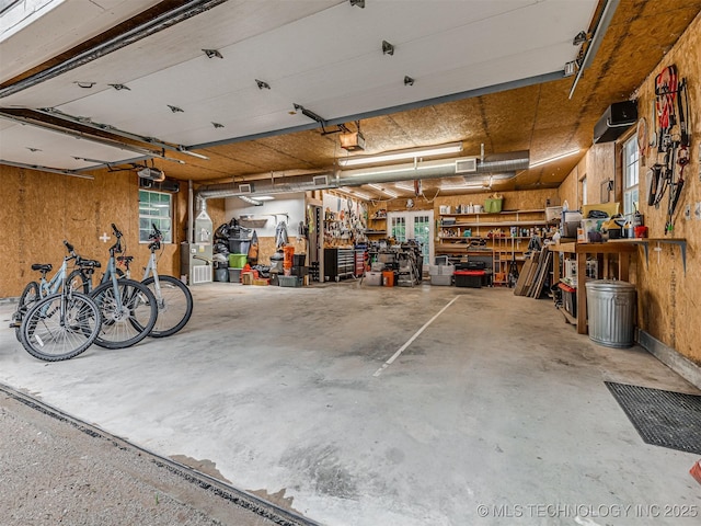 333 Springview Dr, Skiatook, OK 74070 - garage with a workshop area and a garage door opener