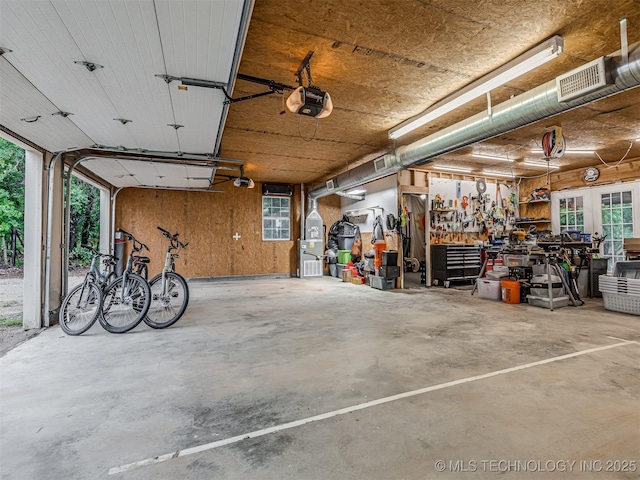 333 Springview Dr, Skiatook, OK 74070 - garage with a garage door opener and a workshop area