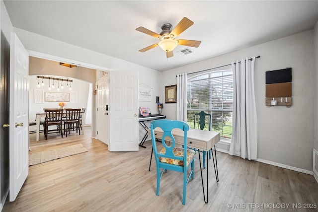 1112 N Yellowood Ave, Broken Arrow, OK 74012 - dining room featuring a ceiling fan, light wood-type flooring, and arched walkways
