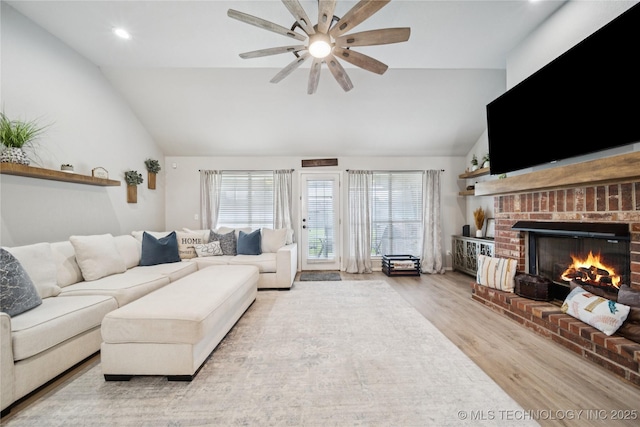 1112 N Yellowood Ave, Broken Arrow, OK 74012 - living room with lofted ceiling, wood finished floors, a ceiling fan, a brick fireplace, and recessed lighting
