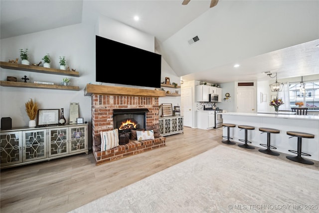 1112 N Yellowood Ave, Broken Arrow, OK 74012 - living area with light wood-style flooring, a brick fireplace, high vaulted ceiling, ceiling fan, and recessed lighting