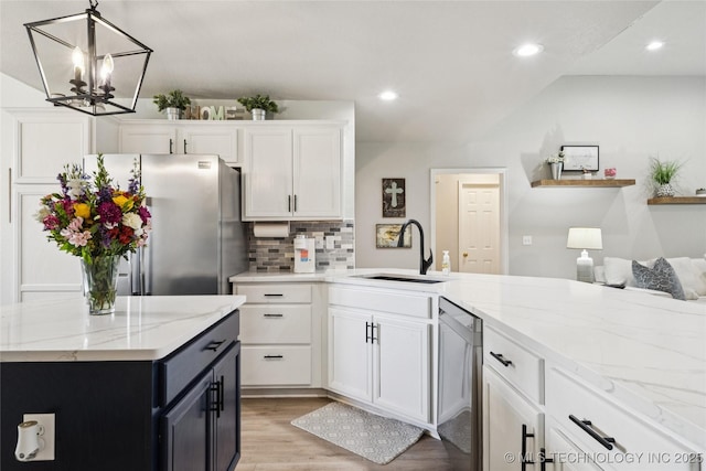 1112 N Yellowood Ave, Broken Arrow, OK 74012 - kitchen featuring stainless steel appliances, light wood finished floors, white cabinetry, backsplash, and a chandelier