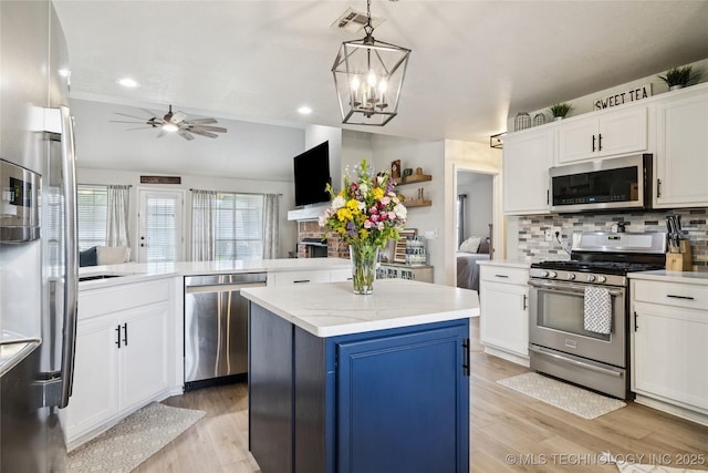 1112 N Yellowood Ave, Broken Arrow, OK 74012 - kitchen featuring appliances with stainless steel finishes, ceiling fan, white cabinets, a kitchen island, and light wood finished floors