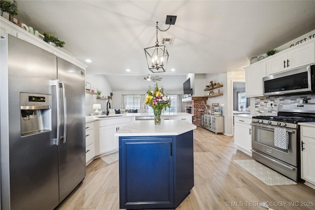 1112 N Yellowood Ave, Broken Arrow, OK 74012 - kitchen featuring appliances with stainless steel finishes, light countertops, a chandelier, a peninsula, and backsplash