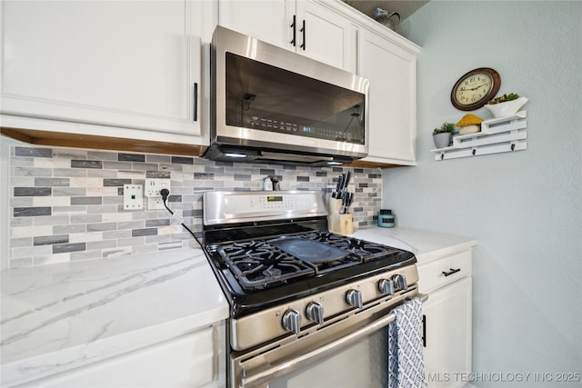 1112 N Yellowood Ave, Broken Arrow, OK 74012 - kitchen with stainless steel appliances, decorative backsplash, white cabinets, and light stone counters
