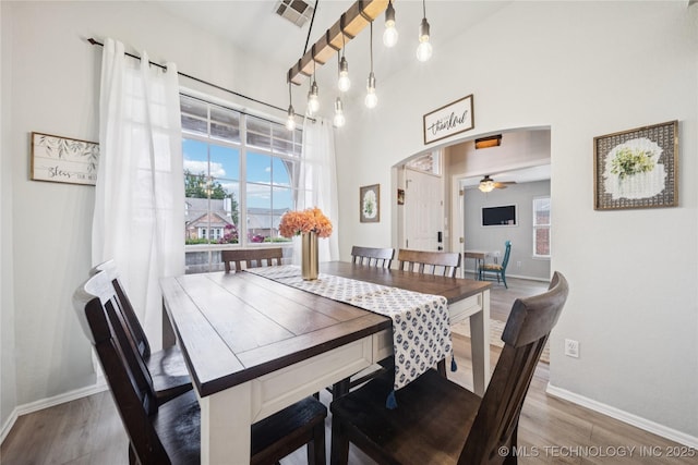 1112 N Yellowood Ave, Broken Arrow, OK 74012 - dining area featuring arched walkways, ceiling fan, and wood finished floors