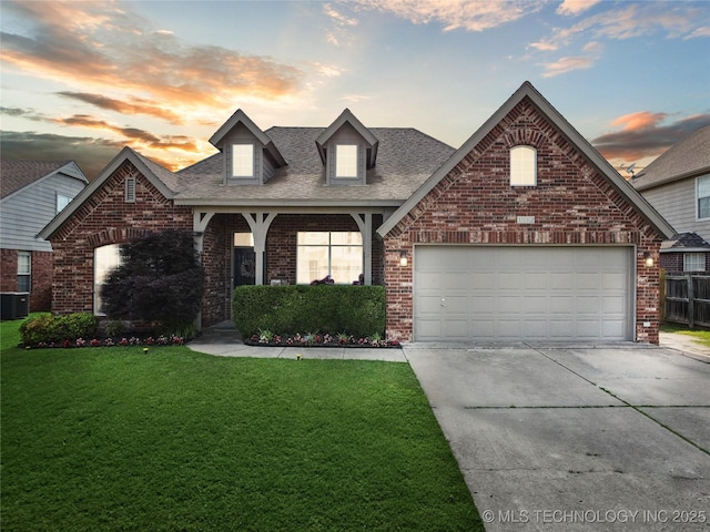 1112 N Yellowood Ave, Broken Arrow, OK 74012 - view of front of home with concrete driveway, a front lawn, brick siding, a shingled roof, and an attached garage