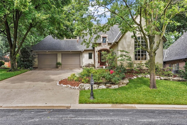 9632 S Vandalia Ave, Tulsa, OK 74137 - view of front of house featuring stucco siding, driveway, an attached garage, a front lawn, and a shingled roof