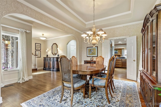 9632 S Vandalia Ave, Tulsa, OK 74137 - dining room with arched walkways, plenty of natural light, wood finished floors, crown molding, and wallpapered walls