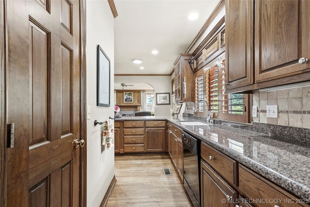 9632 S Vandalia Ave, Tulsa, OK 74137 - kitchen featuring dishwasher, ornamental molding, dark stone countertops, plenty of natural light, and light wood finished floors
