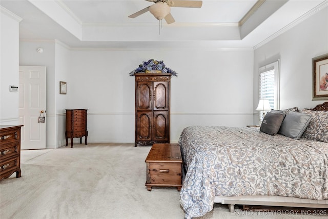 9632 S Vandalia Ave, Tulsa, OK 74137 - carpeted bedroom featuring a tray ceiling, ornamental molding, and a ceiling fan