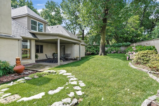 9632 S Vandalia Ave, Tulsa, OK 74137 - fenced backyard featuring a ceiling fan and a patio area
