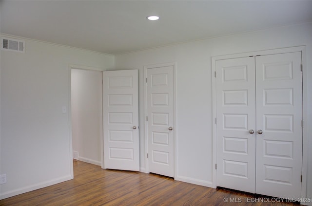 3634 S Pittsburg Ave, Tulsa, OK 74135 - unfurnished bedroom featuring ornamental molding, dark wood-type flooring, recessed lighting, and a closet