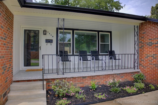 3634 S Pittsburg Ave, Tulsa, OK 74135 - view of exterior entry featuring covered porch and brick siding