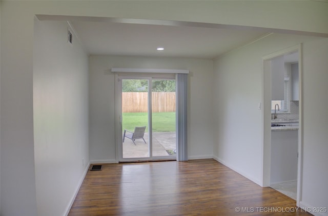 3634 S Pittsburg Ave, Tulsa, OK 74135 - unfurnished room featuring wood finished floors, ornamental molding, and recessed lighting