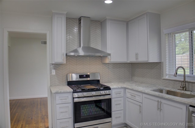 3634 S Pittsburg Ave, Tulsa, OK 74135 - kitchen featuring wall chimney exhaust hood, appliances with stainless steel finishes, light stone countertops, wood finished floors, and ornamental molding