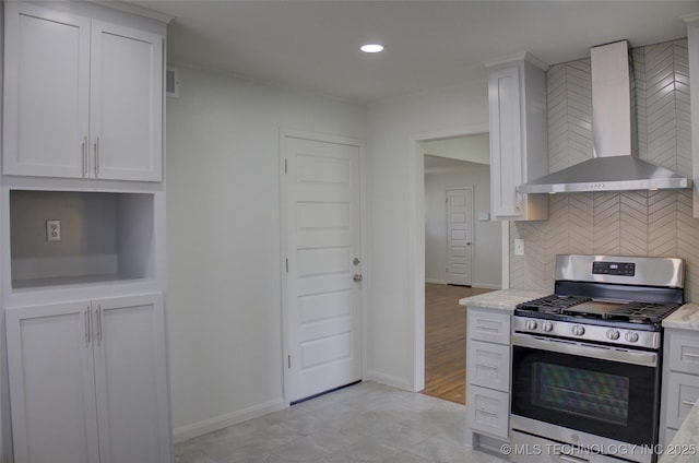 3634 S Pittsburg Ave, Tulsa, OK 74135 - kitchen with wall chimney exhaust hood, stainless steel range with gas cooktop, white cabinetry, backsplash, and recessed lighting