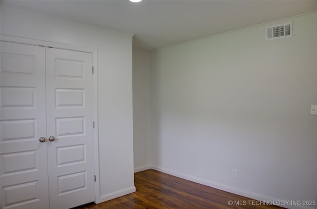 3634 S Pittsburg Ave, Tulsa, OK 74135 - spare room with crown molding and dark wood-type flooring