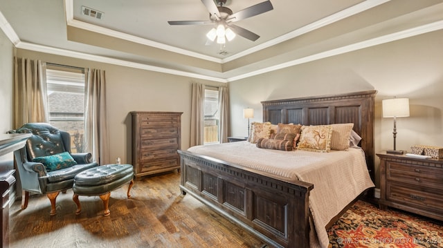 7920 N 147th E Ave, Owasso, OK 74055 - bedroom with a tray ceiling, multiple windows, dark wood-type flooring, ornamental molding, and ceiling fan