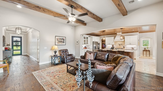 7920 N 147th E Ave, Owasso, OK 74055 - living room featuring arched walkways, a ceiling fan, dark wood-style floors, beamed ceiling, and recessed lighting