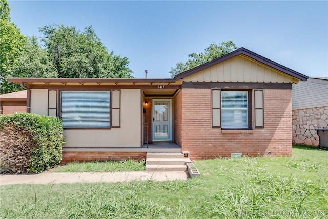 1417 Downing St, Oklahoma City, OK 73120 - view of front of property with a front lawn and brick siding