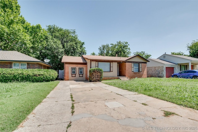 1417 Downing St, Oklahoma City, OK 73120 - ranch-style home with a front lawn, brick siding, and concrete driveway