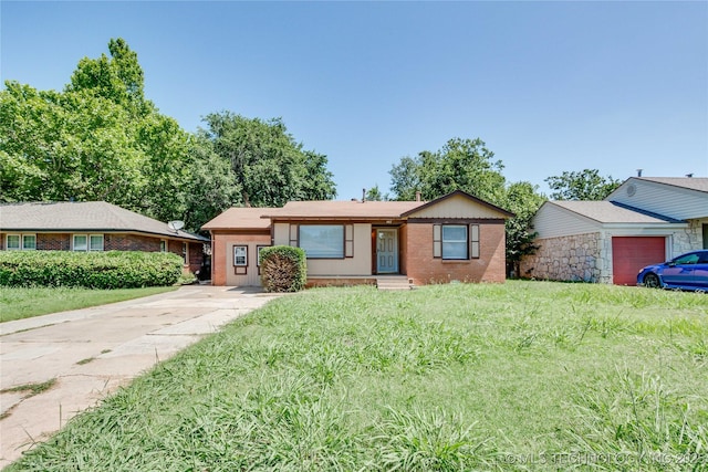 1417 Downing St, Oklahoma City, OK 73120 - ranch-style home featuring brick siding, driveway, and a front yard
