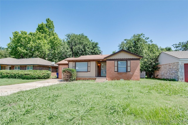 1417 Downing St, Oklahoma City, OK 73120 - single story home featuring brick siding, driveway, an attached garage, and a front lawn