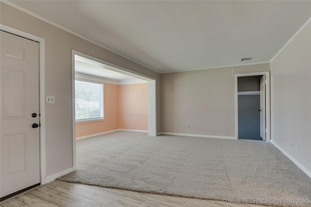 1417 Downing St, Oklahoma City, OK 73120 - unfurnished room featuring crown molding, carpet, and wood finished floors