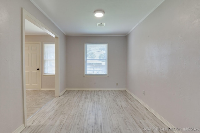 1417 Downing St, Oklahoma City, OK 73120 - unfurnished room featuring light wood-style floors, healthy amount of natural light, and crown molding