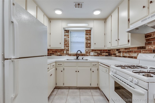 1417 Downing St, Oklahoma City, OK 73120 - kitchen featuring white appliances, under cabinet range hood, light tile patterned flooring, light countertops, and tasteful backsplash
