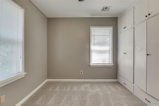 1417 Downing St, Oklahoma City, OK 73120 - unfurnished bedroom featuring light colored carpet and baseboards