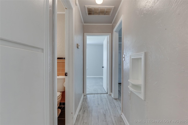1417 Downing St, Oklahoma City, OK 73120 - hallway featuring light wood finished floors and ornamental molding