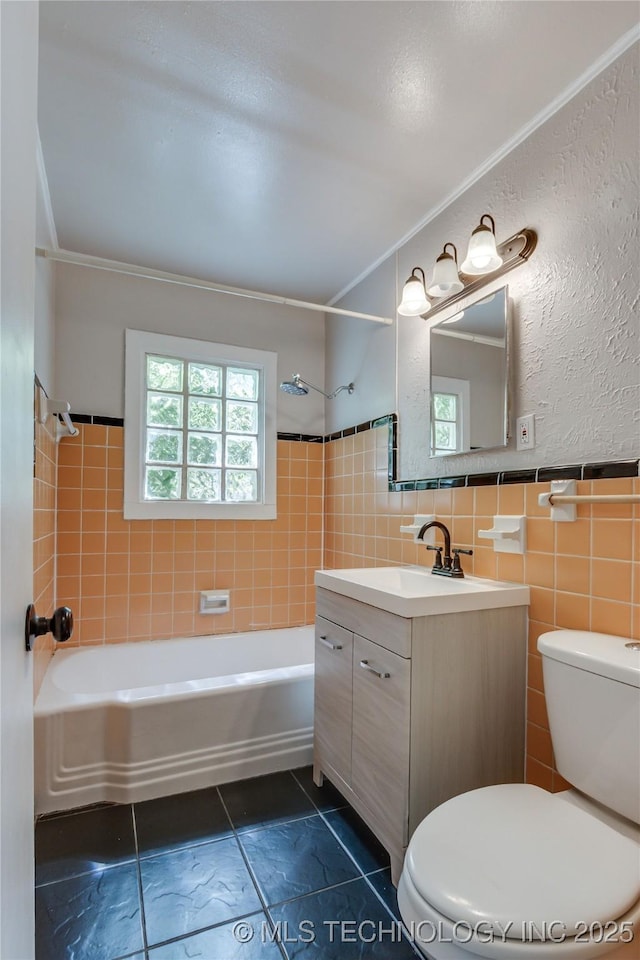 1417 Downing St, Oklahoma City, OK 73120 - full bathroom with washtub / shower combination, tile patterned flooring, vanity, tile walls, and crown molding