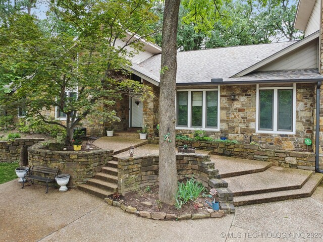 3334 E 100th Pl, Tulsa, OK 74137 - view of front of home with roof with shingles and stone siding