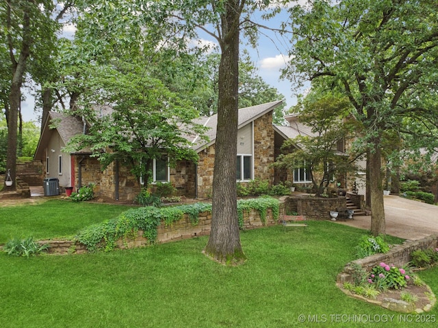 3334 E 100th Pl, Tulsa, OK 74137 - view of front facade featuring stone siding, a front yard, a shingled roof, and a chimney