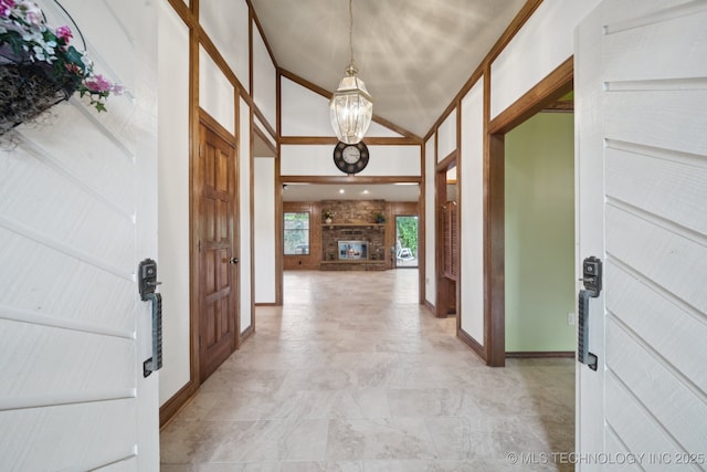 3334 E 100th Pl, Tulsa, OK 74137 - entrance foyer with a chandelier, high vaulted ceiling, and a stone fireplace