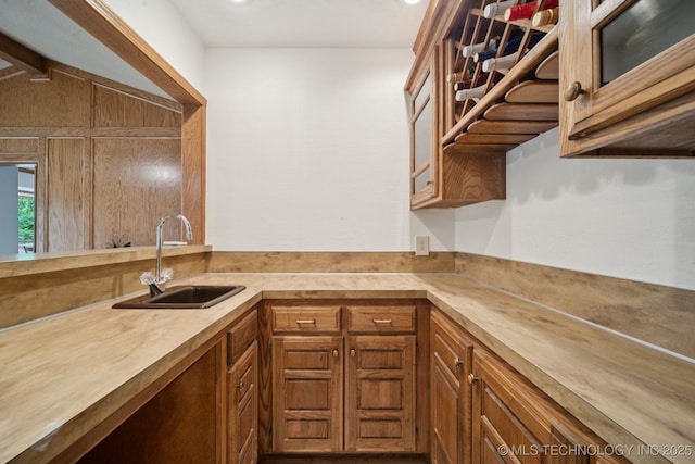 3334 E 100th Pl, Tulsa, OK 74137 - kitchen with glass insert cabinets, brown cabinets, and recessed lighting