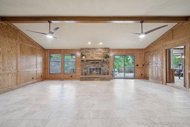 3334 E 100th Pl, Tulsa, OK 74137 - unfurnished living room featuring a ceiling fan, wooden walls, and a stone fireplace