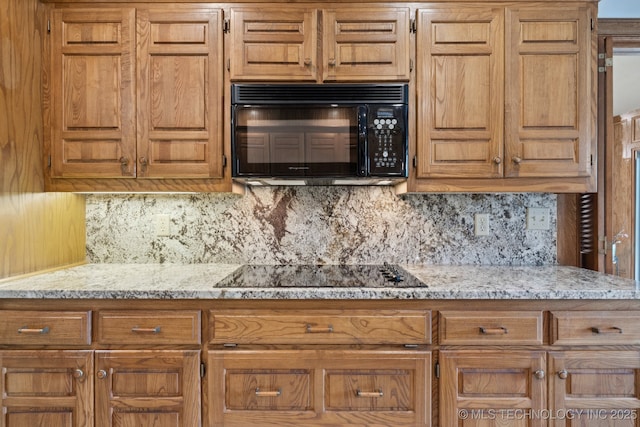 3334 E 100th Pl, Tulsa, OK 74137 - kitchen with black appliances, tasteful backsplash, and brown cabinets