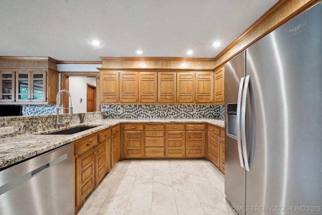 3334 E 100th Pl, Tulsa, OK 74137 - kitchen featuring stainless steel appliances, recessed lighting, light stone counters, brown cabinetry, and tasteful backsplash