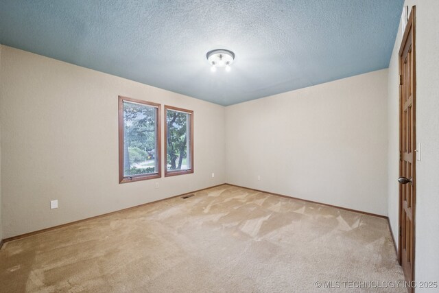3334 E 100th Pl, Tulsa, OK 74137 - empty room featuring carpet flooring and a textured ceiling