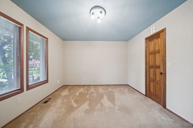 3334 E 100th Pl, Tulsa, OK 74137 - additional living space with light colored carpet and a textured ceiling