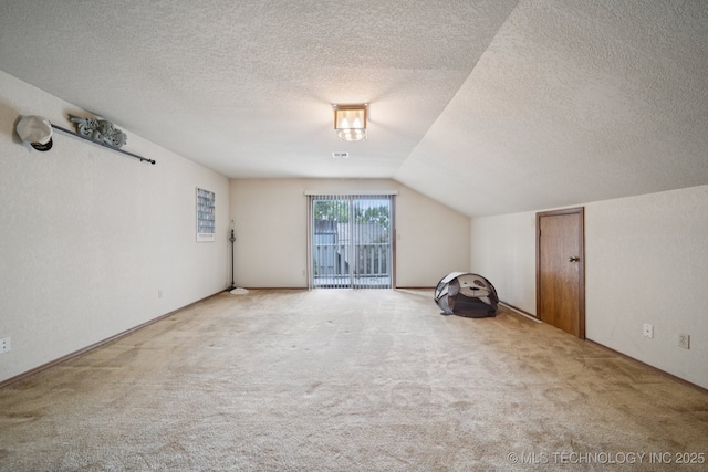 3334 E 100th Pl, Tulsa, OK 74137 - bonus room featuring carpet floors, lofted ceiling, and a textured ceiling