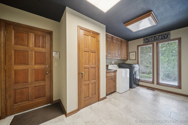 3334 E 100th Pl, Tulsa, OK 74137 - laundry area with cabinet space and washing machine and dryer