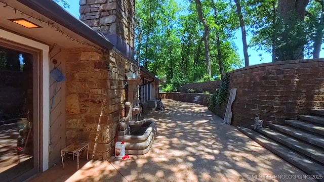 3334 E 100th Pl, Tulsa, OK 74137 - view of property exterior featuring a chimney and a patio