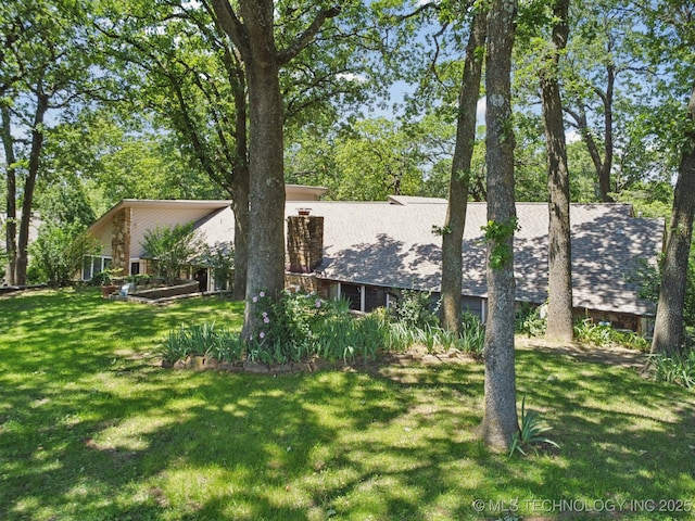 3334 E 100th Pl, Tulsa, OK 74137 - view of front of home featuring a front lawn and a shingled roof