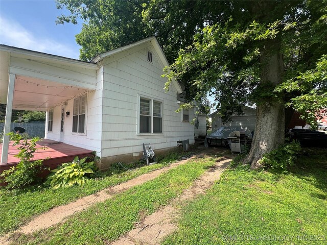 106 N Jordan St, Cleveland, OK 74020 - view of side of home featuring a deck