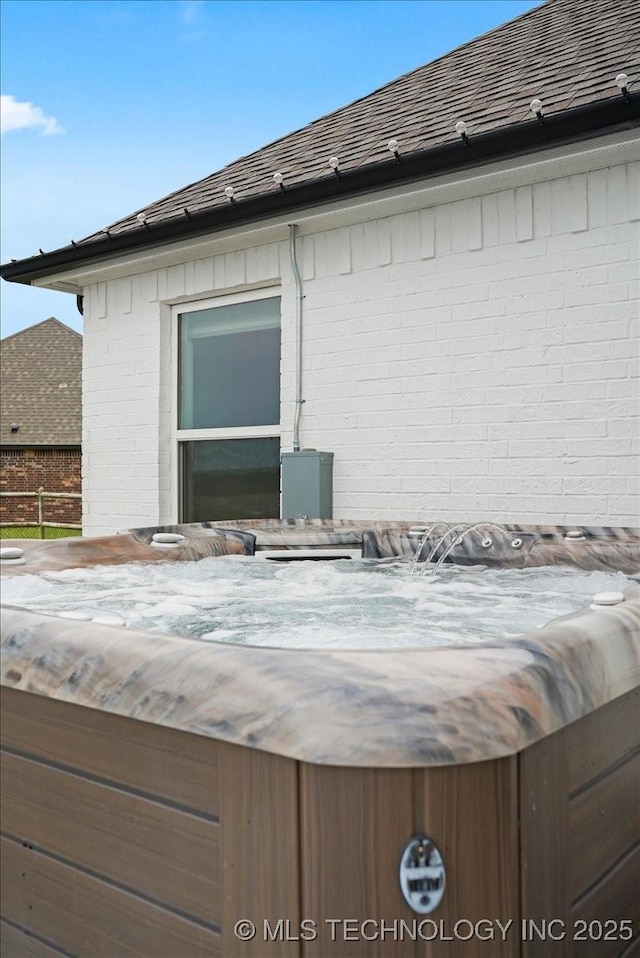 7107 E 88th St N, Owasso, OK 74055 - exterior view of a jacuzzi, brick siding, and a shingled roof