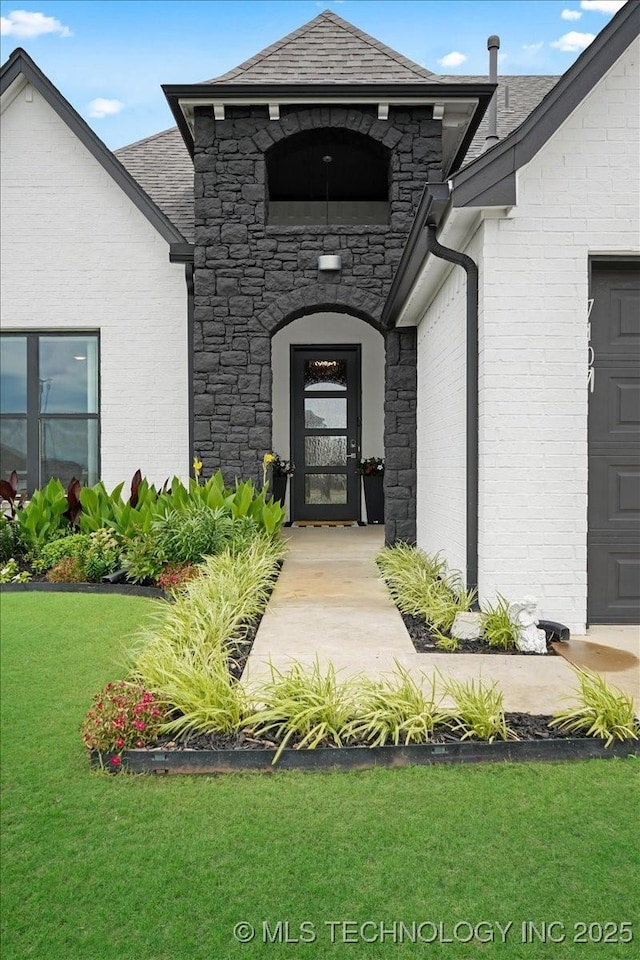 7107 E 88th St N, Owasso, OK 74055 - entrance to property with a yard and stone siding